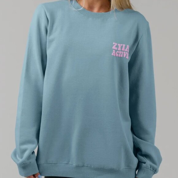 ZYIA Tops - Zyia Light Blue Pillars Crewneck Sweatshirt